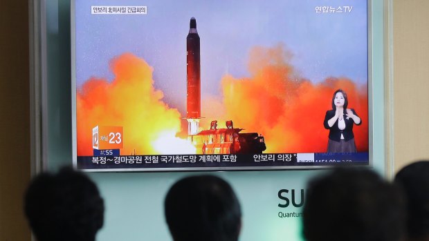 Anxious South Koreans watch footage of a North Korean ballistic missile launch last year