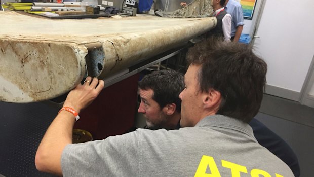 Australian Transport Safety Bureau  staff examine a piece of aircraft debris found off the coast of Tanzania at their laboratory in Canberra last year.