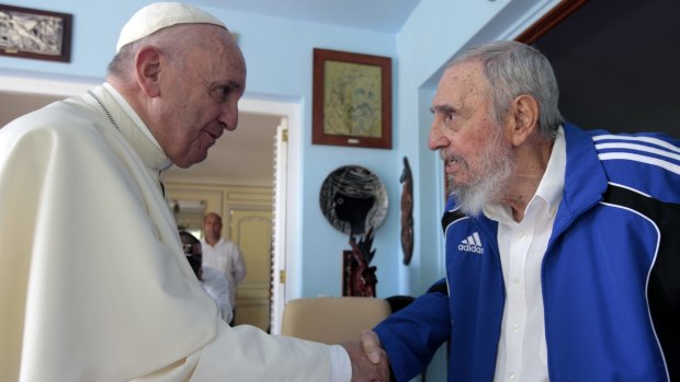 Pope Francis and Cuba's Fidel Castro shake hands in Havana on Sunday.