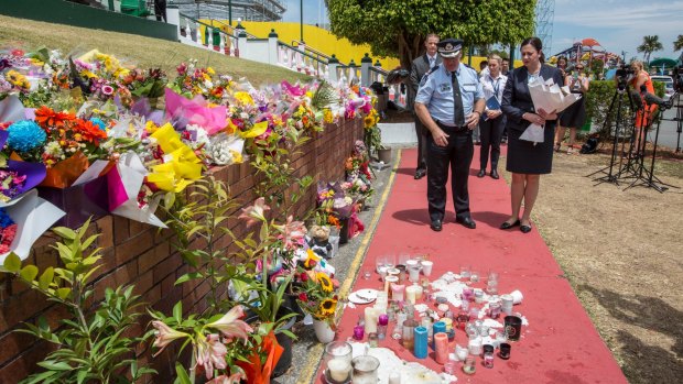 Queensland Premier Annastacia Palaszczuk and Assistant Commissioner Brian Codd pay their respects at Dreamworld on Thursday.