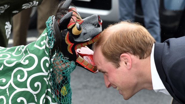 Prince William is greeted by a lion dance during his visit to the Chime of Hope Shopping Centre in Onagawa, Miyagi prefecture.