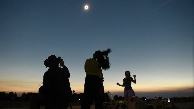 Julian Ledger, of Los Angeles, photographs the solar eclipse in Albany, Oregon.