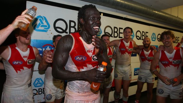 Swans debutant Aliir Aliir joins his teammates to sing the team song after the game.
