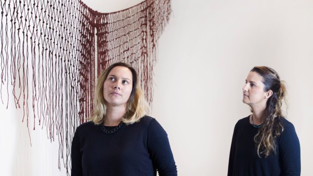 Artist Lucy Simpson and <i>Primavera</i> curator Nicole Foreshew with <i>Yilaalu</i>, a string and ochre artwork inspired by Simpson's connection with the country. 