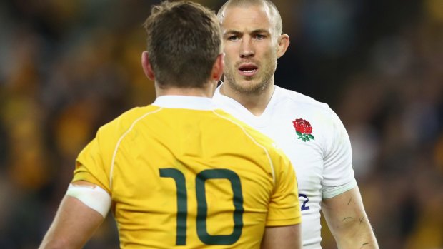 No love lost: Bernard Foley of the Wallabies and Mike Brown of England exchange words.