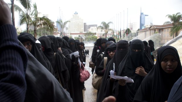Kenyan Muslim women wait in a queue to be checked by security the Islamic Conference in Nairobi on Sunday.