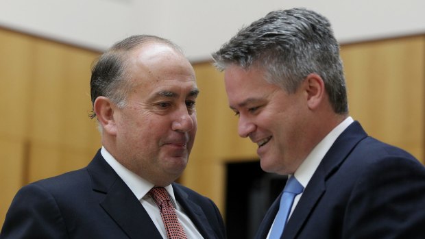 Secretary of Treasury John Fraser confers with Finance Minister Mathias Cormann. 