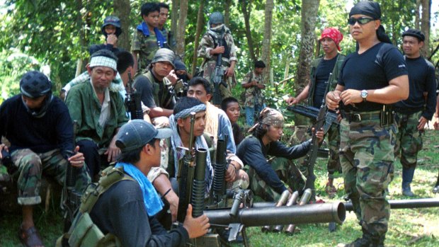Abu Sayyaf spokesman Abu Sabaya, right foreground, with militants in Basilan, the Philippines. 