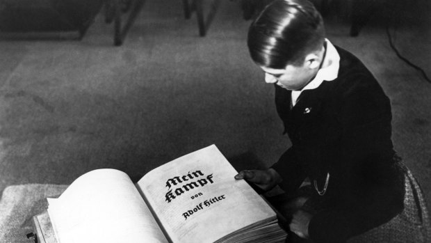 A young German boy opens a copy of Adolf Hitler's political treatise in December 1938. A controversial reprint of the of the 2000-page book will be available in January.