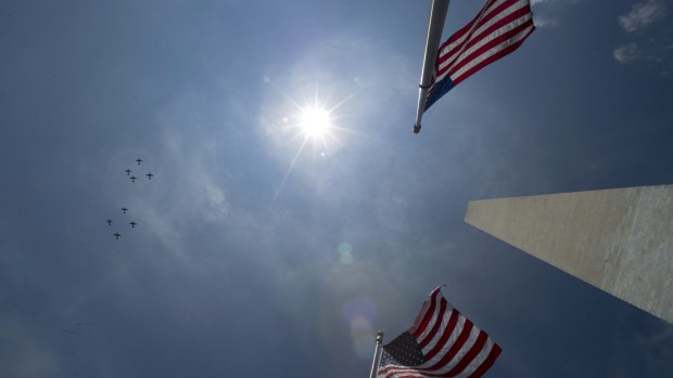 WWII-era US planes fly over the Washington Monument