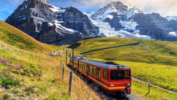 Famous electric red tourist train coming down from the Jungfraujoch station (top of Europe) in Switzerland.