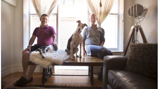 Marco Pugnaloni, left, with Paul Jewson with their dogs Cloe and Oscar. Both have an apartment they run through Airbnb in St Kilda and are doing very well from the business