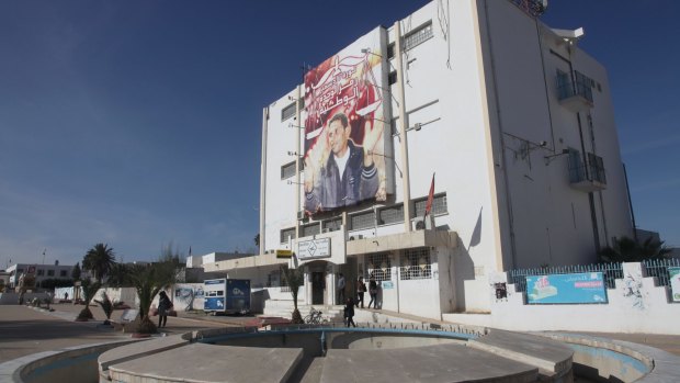 The post office building next to Sidi Bouzid's provincial government building is decorated with a giant poster of Mohamed Bouazizi, "the symbol of national unity".