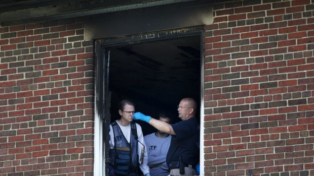 Investigators inspect the fire-damaged multimillion-dollar home.