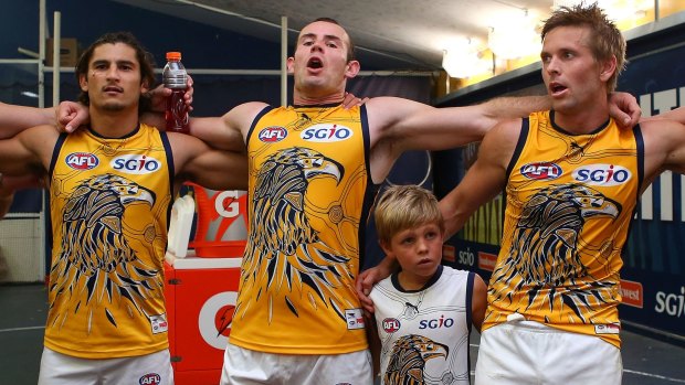 Shannon Hurn leads the Eagles in singing the club song after they defeated Geelong on Sunday.