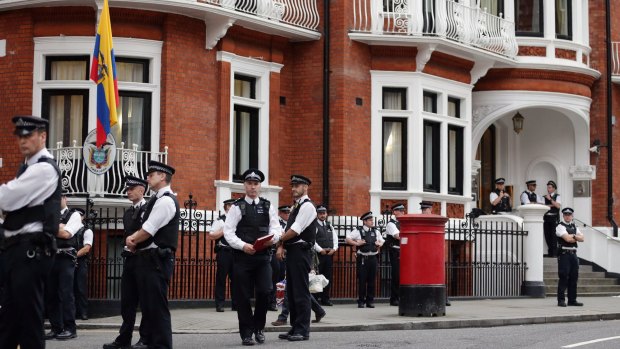Police stand guard outside the embassy where the founder of WikiLeaks is staying.