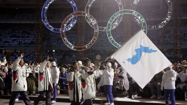 A unification flag is carried into the stadium during the 2006 Winter Olympics in Turin, Italy. 