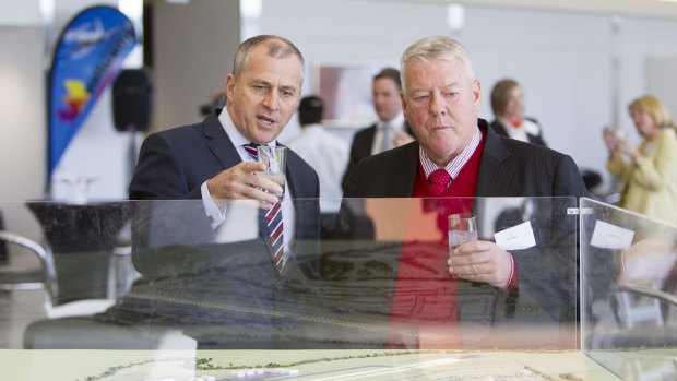 Wagners chairman John Wagner and QantasLink CEO John Gissing look at a model of the new Brisbane West Wellcamp Airport.