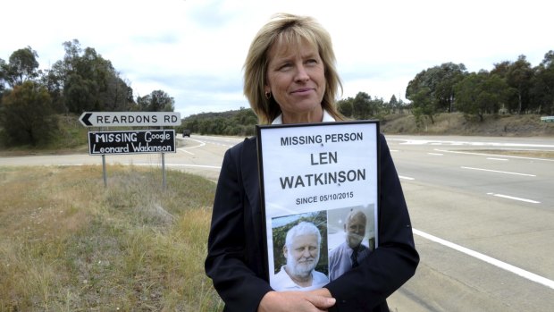 Kate O'Brien, the youngest sister of Leonard Watkinson, with the missing person poster and sign on the Hume Highway.