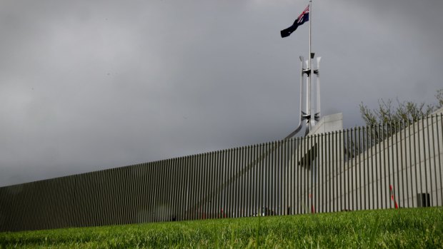 The security fence nears completion at Parliament House on Monday.