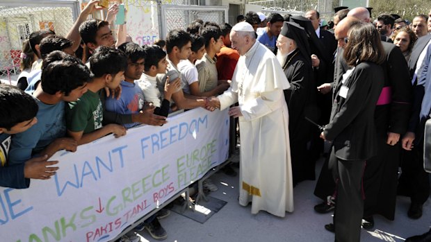 Pope Francis and Ecumenical Patriarch Bartholomew I, greet migrants and refugees during a visit on the Greek island of Lesbos.