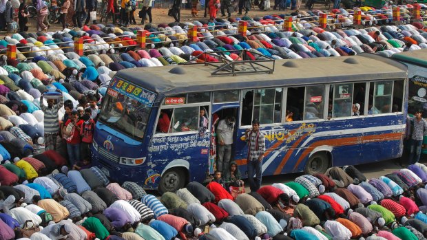  Bangladeshi Muslim devotees offer prayers  in Tongi, 20 kilometres  north of Dhaka, Bangladesh. 