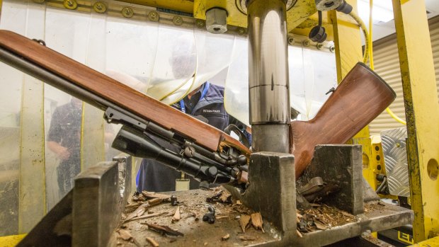 A gun being crushed at the Victoria Police Forensic Centre in Macleod.