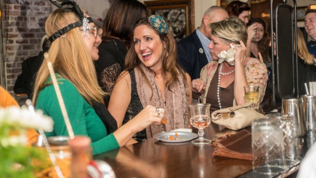  Museum visitors enjoy a drink at the bar.