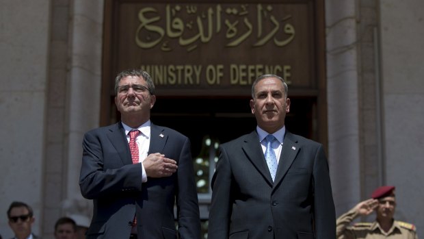 US Defence Secretary Ash Carter (left) and Iraqi Defence Minister Khalid al-Obeidi stand for their country's national anthems in Baghdad on Thursday.