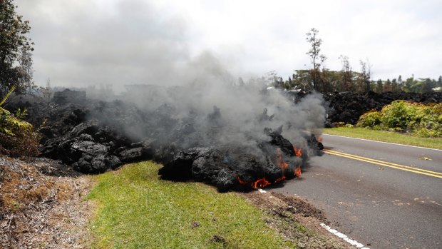 Lava creeps across the road in Pahoa on the Big Island of Hawaii.