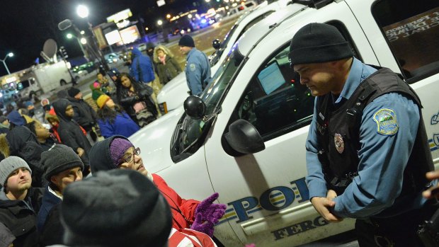 Protesters demonstrate outside the Ferguson Police Department in March. 