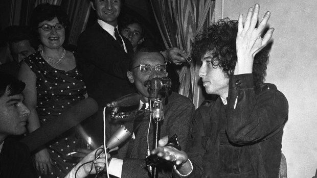 Bob Dylan gestures during a news conference in Paris in 1966.