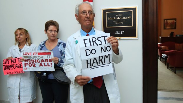 Retired family physician Jay Brock of Fredericksburg, Virginia, joins protests  outside the office of Senate Majority Leader Mitch McConnell on Monday.