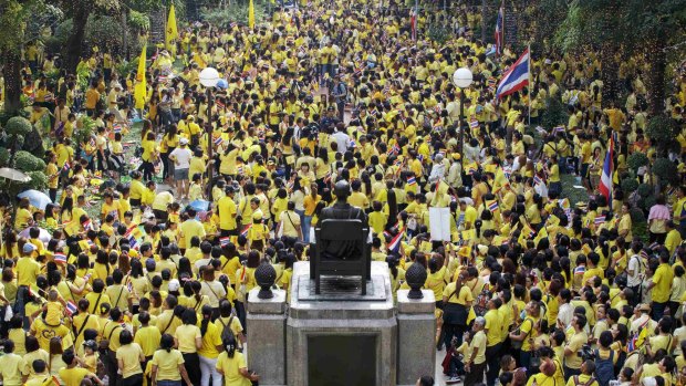 Well-wishers gather to pray for the health and celebrate the birthday of Thailand's King Bhumibol Adulyadej at Siriraj hospital where he is staying. 