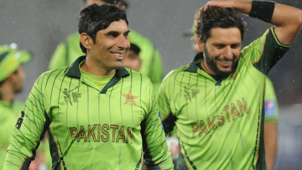 Misbah-ul-Haq and teammate Shahid Afridi leave the field after defeating South Africa.