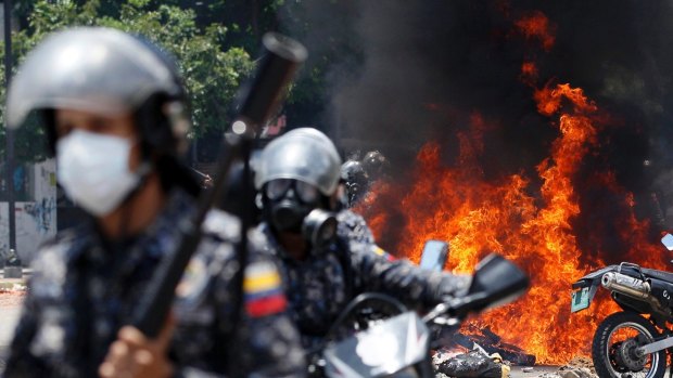 An explosion at Altamira square during polling day clashes in Caracas on Sunday.