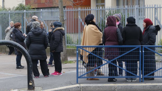 People gather near the pre-school in the Paris suburb of Aubervilliers.