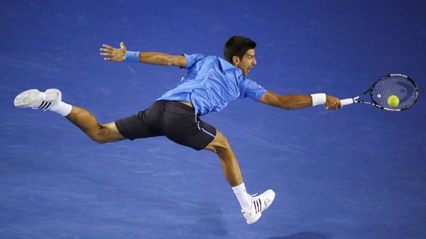 Top seed Novak Djokovic is airborne as he stretches for a backhand against Gilles Muller of Luxembourg on Monday night.