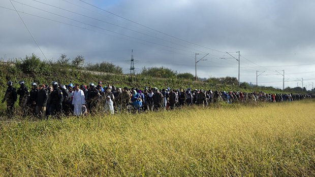 Refugees walk towards a reception facility after crossing into Slovenia from Croatia.