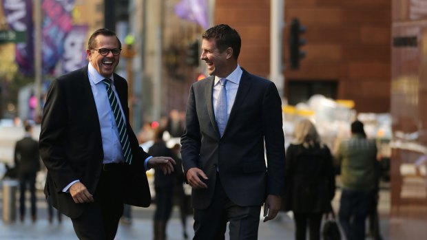 Rob Whitfield, left, famously took a massive pay cut when poached by then NSW premier Mike Baird, right, in 2015.