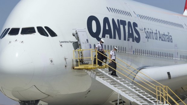 Qantas pilots leave an Airbus A380 after it arrived at Southern California Logistics Airport for storage. 