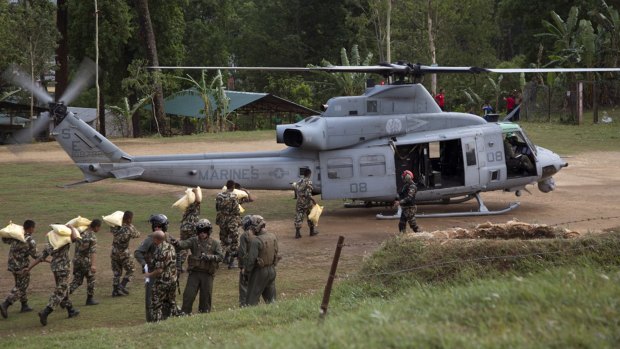Nepalese service members load relief supplies into a US Marine Corps UH-1Y Venom from Joint Task Force 505 at Sindhuli, Nepal. A US Navy helicopter has gone missing, with six US Marines and two Nepalese soldiers aboard, following the second earthquake.