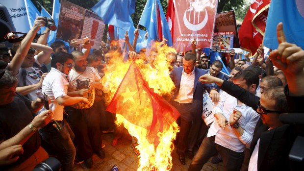 Demonstrators set fire to a Chinese flag during a protest against China near the Chinese consulate in Istanbul, Turkey, in July.