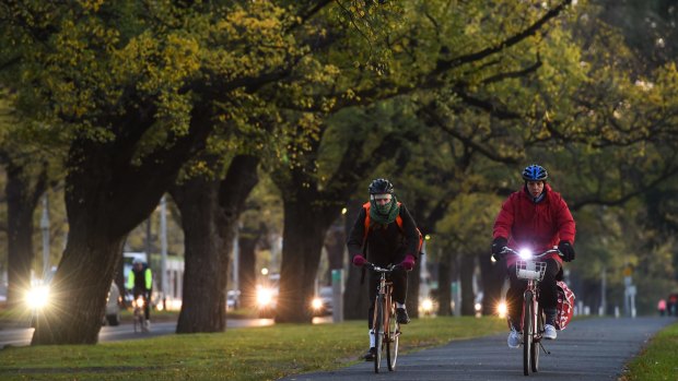 Cyclists ride through Princes Park in cold conditions on Tuesday, the last day of autumn. 
