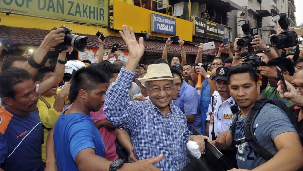 Malaysia's former prime minister Mahathir Mohamad waves to activists at the Bersih rally in Kuala Lumpur at the weekend. 