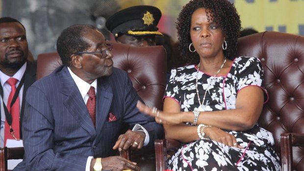 Zimbabwean President Robert Mugabe's wife Grace gestures for him to wait, during celebrations to mark his 92nd birthday in February.