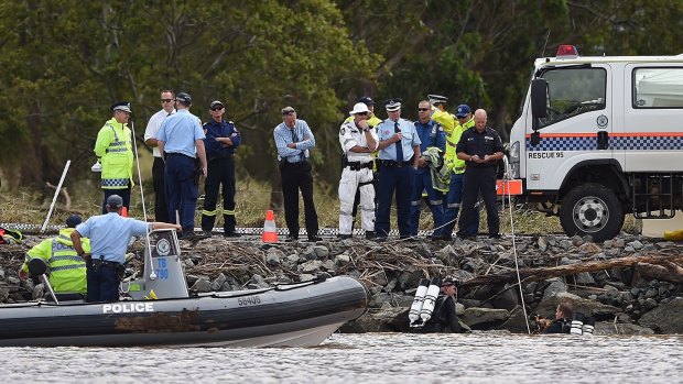 Two police divers at the accident scene on the Tweed River.
