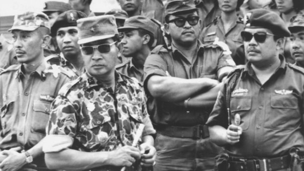 Indonesia's Major-General Suharto, in camouflage uniform, at the funeral for six generals killed by rebels in the abortive attempt to overthrow then president Sukarno in 1965. The coup attempt led to nationwide massacres. 