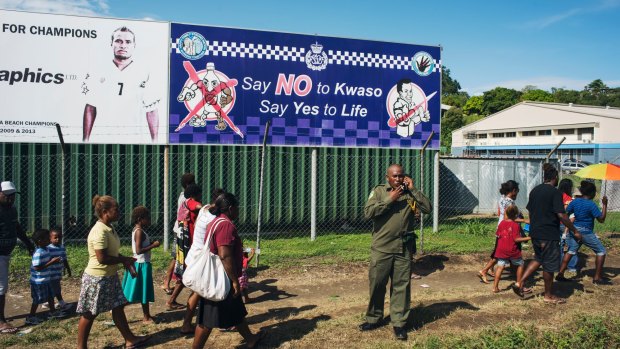 A police sign asking people to say no to Kwaso, a highly potent home-brewed spirit drink, is displayed outside the Lawson Tama Stadium in Honiara.