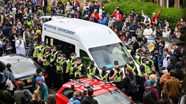 Protestors block a UK Home Office van to stop it from leaving Glasgow on Thursday.